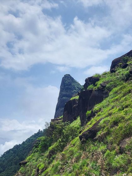 The sharp, majestic peak of Kurinjal as seen from the trail. The final climb is steep but offers incredible close-up views of the rock formations.