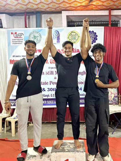 An athlete celebrating his gold medal at the Maharashtra State Championship. A dominant performance with a 605kg total in the 83kg junior category.