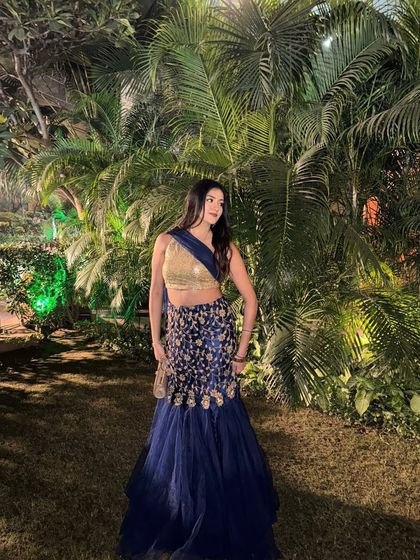 Another angle of the blue lehenga, showing its beautiful embroidery and flow.