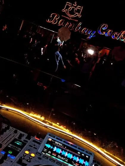 The view from my console at Bombay Cocktail Bar, with the neon lights and the crowd setting the scene for a great night.