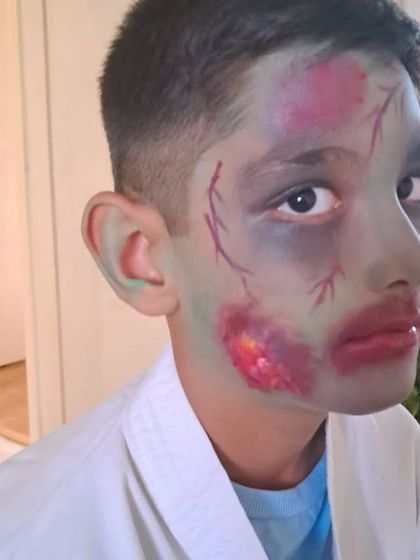 An example of costume prosthetic makeup. For this zombie look, I used special effects techniques to create the illusion of bruised, decaying skin and bloody wounds, perfect for film or a Halloween costume.