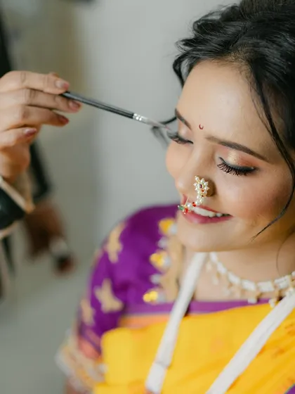 A gentle touch. This photo captures a moment during the makeup application, showing the care and precision I take with every bride.