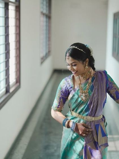 A candid shot of a bride looking out a window, full of anticipation.