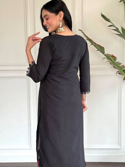 A classic black chanderi kurta with a colorful floral printed dupatta. The heavy thread embroidery on the neckline makes it a perfect blend of simple and festive.