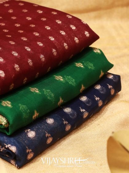 A stack showing the variety of colors available in our Kora silk collection, including maroon, green, and blue.