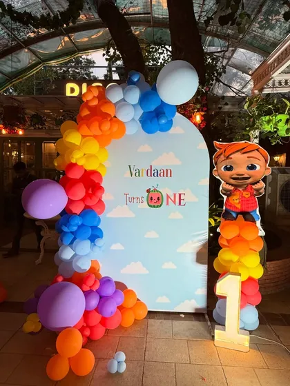 A simple and sweet photo corner for Vardaan's party, with a custom backdrop, a JJ cutout, and a light-up number '1'.