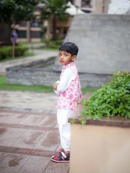 A candid shot of a young boy during his outdoor birthday photoshoot. We capture those in-between moments that reveal a child's true personality.