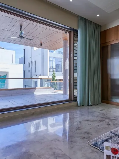 This bedroom opens up to a large private balcony through floor-to-ceiling sliding doors. It’s a perfect example of creating a seamless indoor-outdoor living experience.