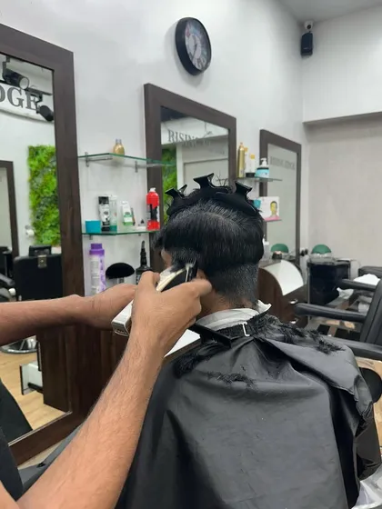 Sectioning the hair with clips allows for greater control and precision, ensuring a balanced and symmetrical haircut.