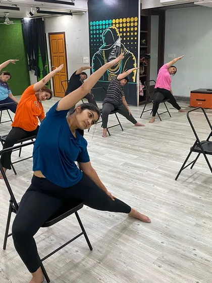 Our members using chairs to support a side-body stretch, which helps improve flexibility in the spine and waist.
