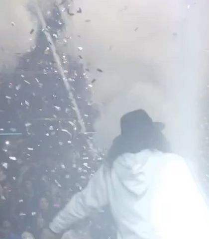 A shot of me on stage during a massive event with DJ Chetas. The air is thick with confetti and smoke, capturing the peak energy of a headline performance at F Superclub.