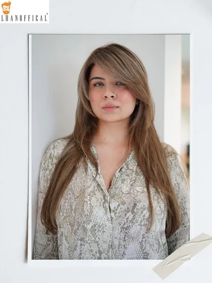 This icy blonde hair color is a statement. The long layers and side-swept bangs complete this modern and chic look.