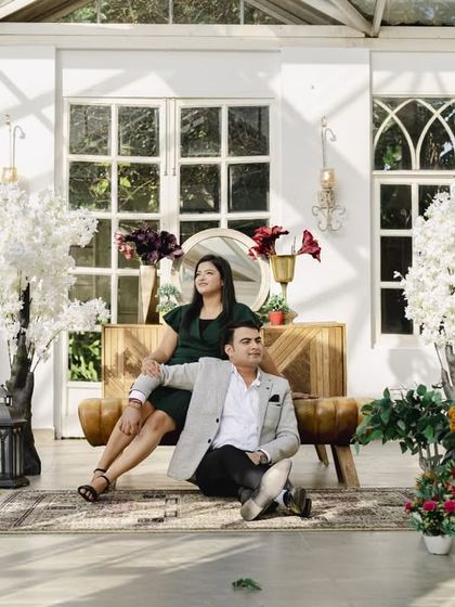 A wider shot of the couple in the elegant glasshouse setting, showing the beautiful decor and lighting we can use to create a stunning pre-wedding album.