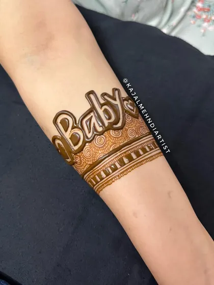 A close-up of the 'Baby' henna band for a mom-to-be. The bold, 3D-style lettering makes a sweet and stylish statement.