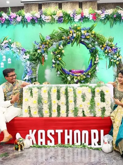 For this naming ceremony, I created a personalized stage featuring the baby's name, "NIHIRA," crafted from fresh white flowers. The backdrop of green foliage and a floral wreath provided a beautiful setting for the family's special day.