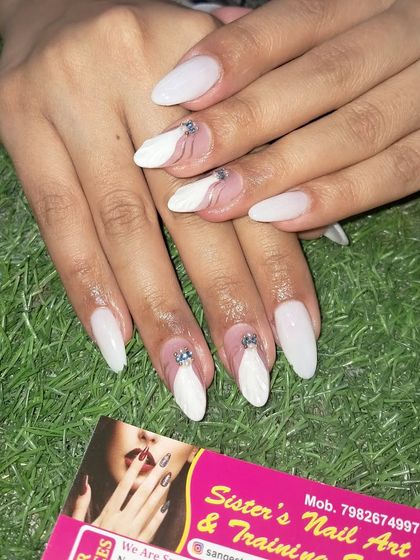 An elegant design featuring white sculpted feathers on a sheer base, accented with a few rhinestones.