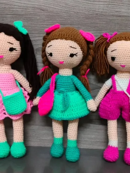Three lovely dolls, each with a unique color combination and hairstyle. They make a beautiful group of friends.