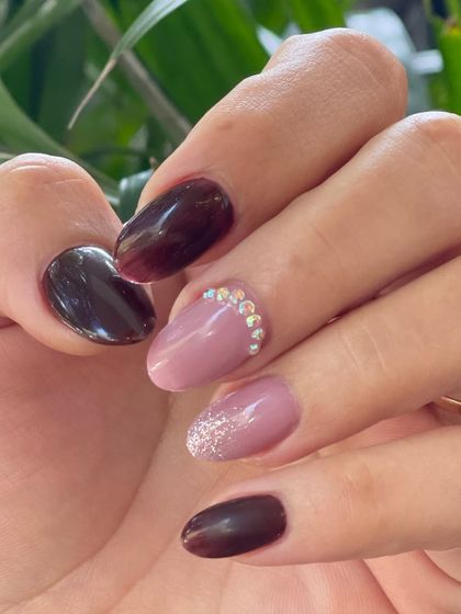 A close-up showcasing the detail of this manicure, with a crescent of delicate crystals along the cuticle of the accent nail.