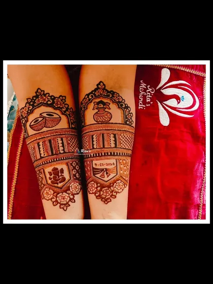 A close-up of the arm design for a bridal client, featuring traditional dhol and kalash motifs.