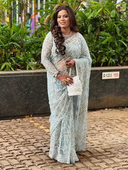A full-length view of the beautiful embroidered saree, showing how a simple jewellery set can perfectly complete an elegant look.