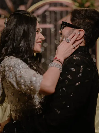 A candid, playful moment during the sangeet. This photo captures the fun-loving chemistry of the couple, full of smiles and genuine affection.