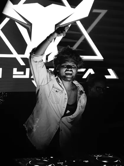 In the zone. A powerful black and white image of me hyping up the crowd, arm raised, with my logo glowing behind me.