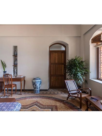 A study area within a larger room, demonstrating how we use antique furniture and thoughtful placement to define functional zones without walls, preserving the open feel of the heritage home.