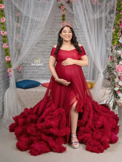 A regal portrait in a deep red gown, complete with a crown. This setup is perfect for moms who want to feel like royalty.