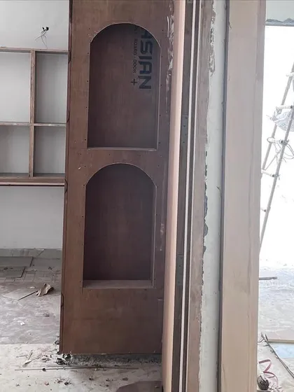 A kids' room during the construction phase. This image shows the raw plywood structure for the wardrobe and study nook, which will later be transformed into a whimsical and functional space.