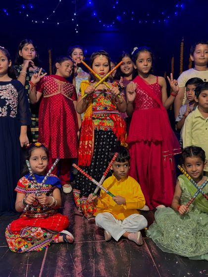 Our kids' batch posing with their dandiya sticks during our Navratri dance showcase.