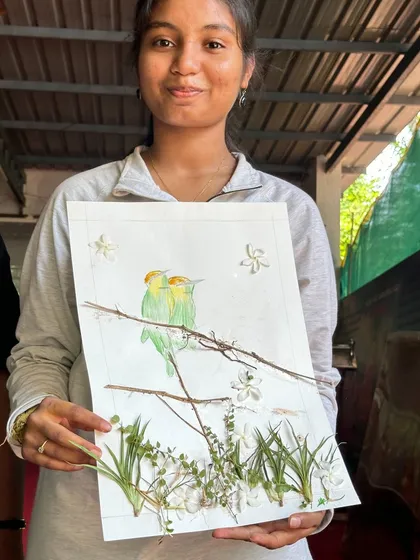 A beautiful depiction of lovebirds, crafted from flowers and leaves, by a talented participant at our Ulavi camp.