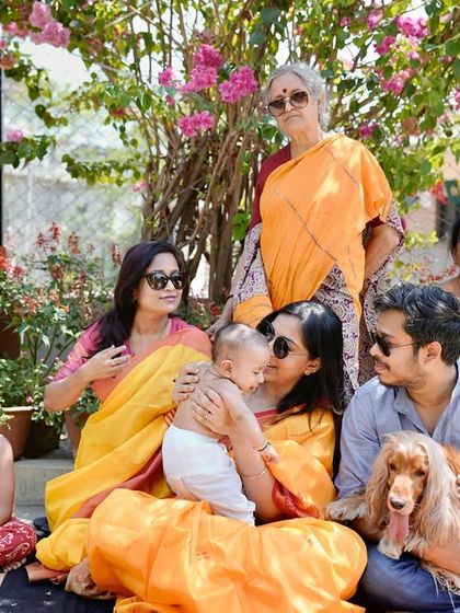 A multi-generational family photo from the 'Gaye Holud,' filled with color, sunshine, and love.