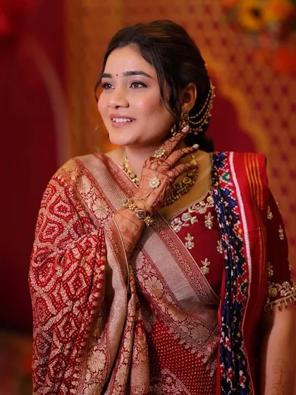 A close-up showing the beautiful details of her makeup and the intricate hair accessory. This is traditional elegance at its best.