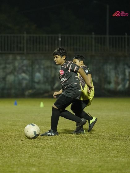 A training drill focusing on strength and shielding the ball from an opponent.