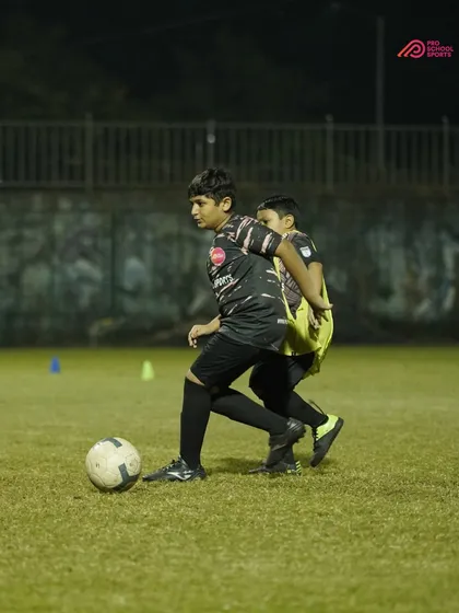 A training drill focusing on strength and shielding the ball from an opponent.