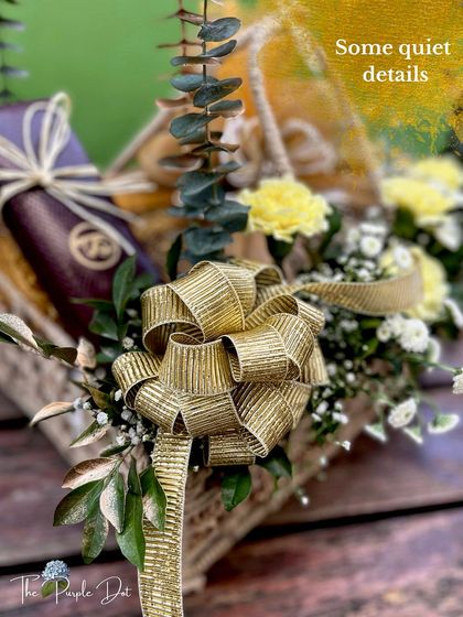 Quiet details are at the heart of my work. This close-up shows a perfectly tied gold bow and a carefully wrapped gift, showcasing the craftsmanship that goes into every single hamper I create.