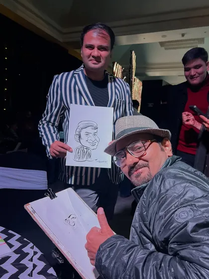 Posing with a happy guest and his new caricature. It’s always a pleasure to see the final result bring a smile.