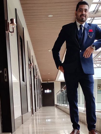 This is a custom three-piece suit, showing how a waistcoat adds another layer of formality. The fit is kept modern and sharp, not boxy.