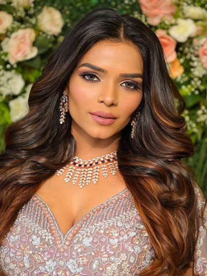 A full view of the lilac goddess look. The open hairstyle with soft waves perfectly balances the drama of the eye makeup.