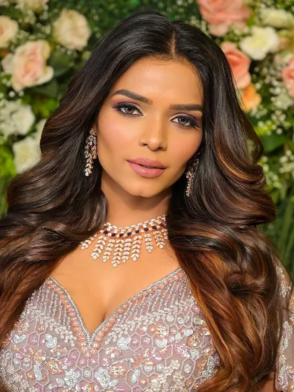A full view of the lilac goddess look. The open hairstyle with soft waves perfectly balances the drama of the eye makeup.
