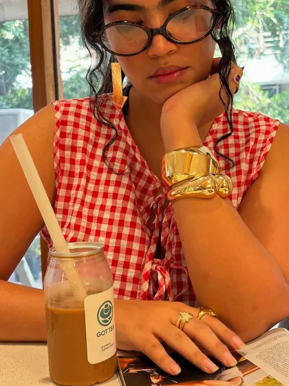 Channeling my inner Carrie Bradshaw. A close-up on my chunky gold cuff and rings while I pretend to read Vogue. Statement jewelry is a must in my book.
