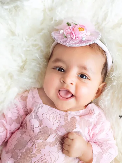 That cheeky little smile and tongue sticking out is just adorable. These playful expressions are what make milestone sessions so much fun.