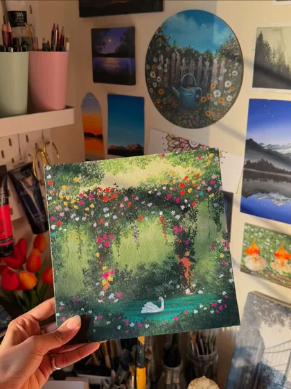 A finished acrylic painting of a graceful swan in a secret garden pond. I wanted this piece to feel like a scene from a fairy tale, with countless flowers creating a lush, colorful arch.
