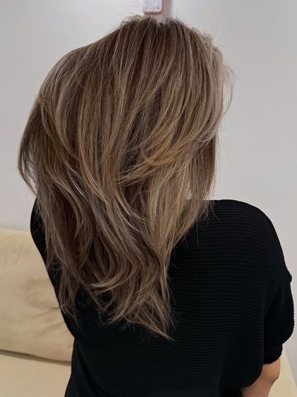 Another shot of this soft and buttery blonde look. The color has a natural depth that prevents it from looking flat, giving it a rich, healthy appearance.