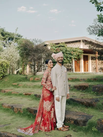 A full-length portrait set against the lush greenery of their wedding venue. The couple's happy, relaxed smiles show the joy of the day. This image showcases my ability to capture beautiful portraits in natural, expansive settings.