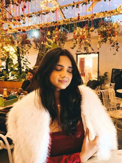A candid moment during our Christmas outing. The white fur jacket adds a touch of glamour and warmth to the simple red velvet dress.