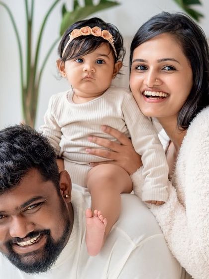 A happy family of three posing for a portrait.