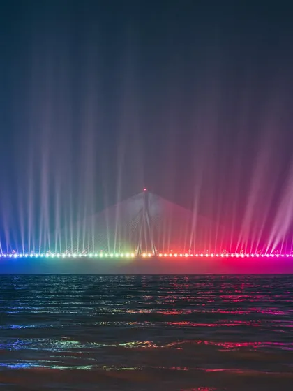 The Bandra-Worli Sea Link lit up with a spectacular rainbow light show. A truly magical night-time shot that showcases the modern side of Mumbai.