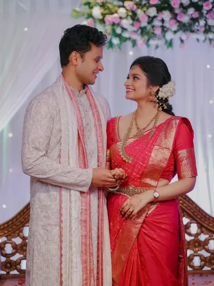 A sweet moment between the engaged couple as they look at each other, surrounded by the soft decor of their ceremony.