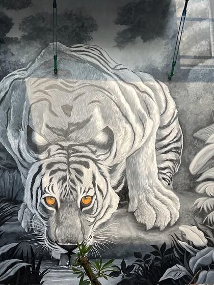 A wide angle view of the completed tiger mural, showing its impressive scale on the wall. This perspective gives a sense of how such a large piece can dominate and define a space.